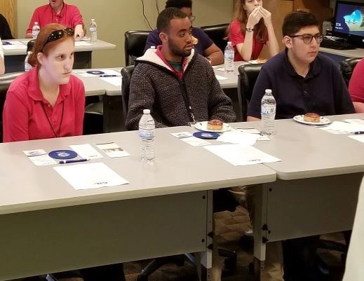 Navarre High School Transition Training Students sitting at a a long table