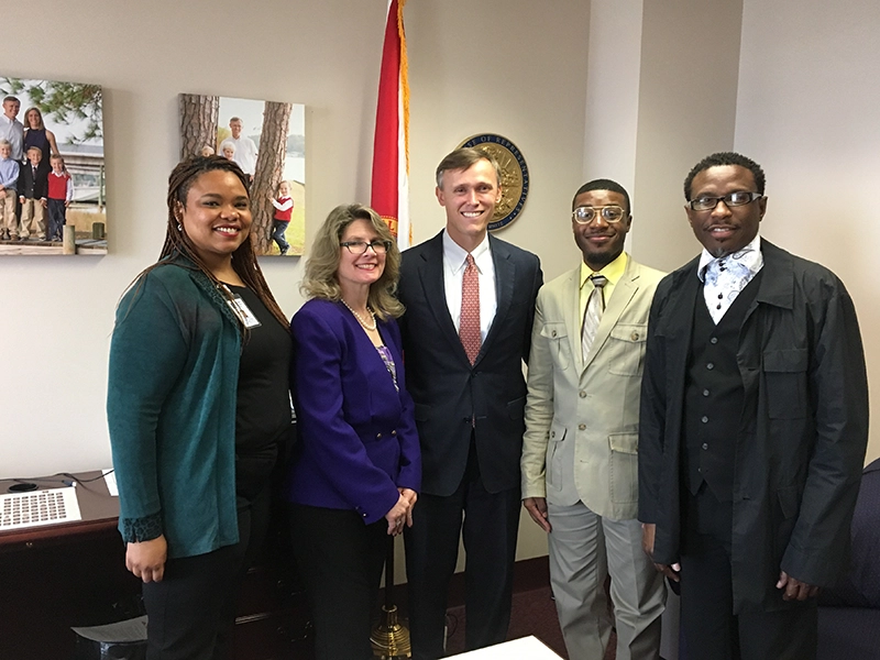 Pensacola consumers, Executive Director Carolyn Grawi, former team member Lavesta Faegin, talking with former State Representative Frank White.