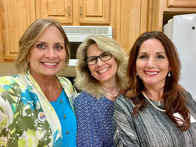 Carolyn, Barb, and Ms Salzman smiling together in a group selfie